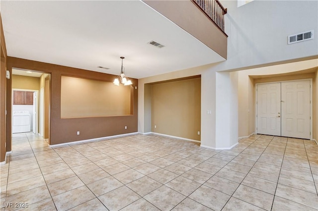 5949 Casa Coronado Ave, Las Vegas, NV 89131 - empty room featuring washer / clothes dryer, light tile patterned floors, a chandelier, and baseboards