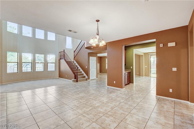 5949 Casa Coronado Ave, Las Vegas, NV 89131 - empty room featuring a chandelier, light tile patterned floors, stairs, and baseboards