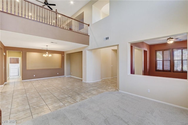 5949 Casa Coronado Ave, Las Vegas, NV 89131 - unfurnished living room with ceiling fan, tile patterned floors, a towering ceiling, baseboards, and a chandelier