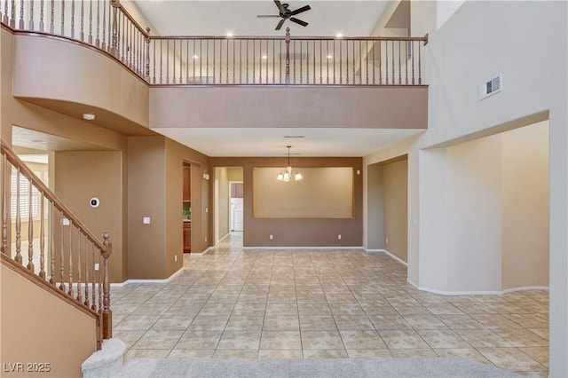 5949 Casa Coronado Ave, Las Vegas, NV 89131 - unfurnished living room with a high ceiling, a ceiling fan, stairway, baseboards, and tile patterned flooring