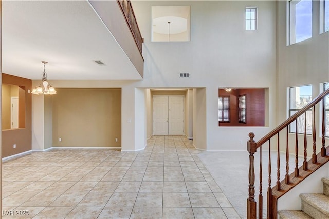 5949 Casa Coronado Ave, Las Vegas, NV 89131 - foyer entrance featuring a chandelier, light tile patterned floors, stairway, baseboards, and a towering ceiling