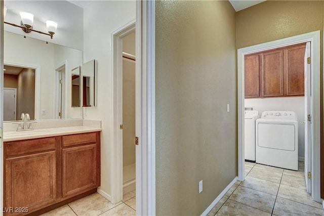 5949 Casa Coronado Ave, Las Vegas, NV 89131 - bathroom featuring tile patterned flooring, vanity, washer and dryer, and baseboards