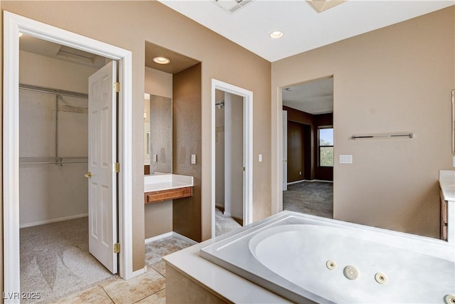 5949 Casa Coronado Ave, Las Vegas, NV 89131 - bathroom featuring a jetted tub, baseboards, a spacious closet, and recessed lighting