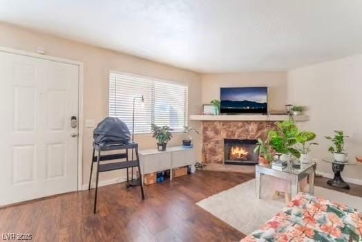 904 Boulder Springs Dr Unit 102, Las Vegas, NV 89128 - living area featuring wood finished floors, a fireplace, and baseboards