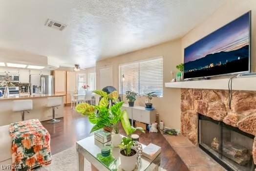 904 Boulder Springs Dr Unit 102, Las Vegas, NV 89128 - living room with a fireplace, a ceiling fan, and finished concrete floors