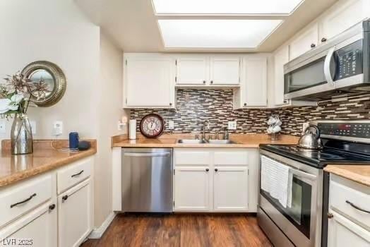 904 Boulder Springs Dr Unit 102, Las Vegas, NV 89128 - kitchen featuring stainless steel appliances, a sink, backsplash, and light countertops