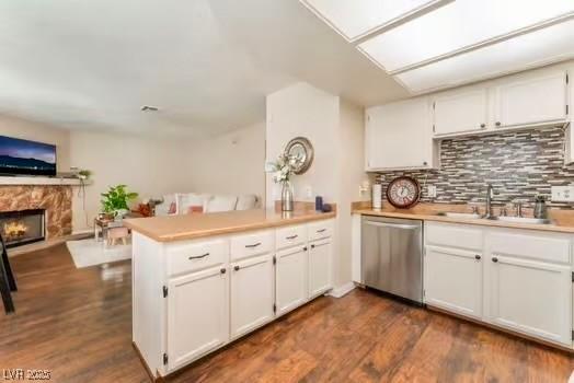 904 Boulder Springs Dr Unit 102, Las Vegas, NV 89128 - kitchen featuring dishwasher, a peninsula, a sink, open floor plan, and light countertops