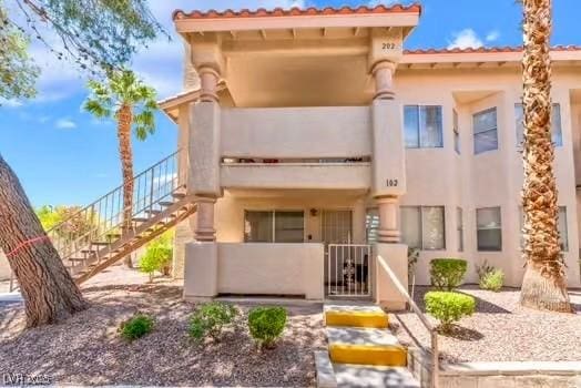 904 Boulder Springs Dr Unit 102, Las Vegas, NV 89128 - view of front facade with stairs and stucco siding