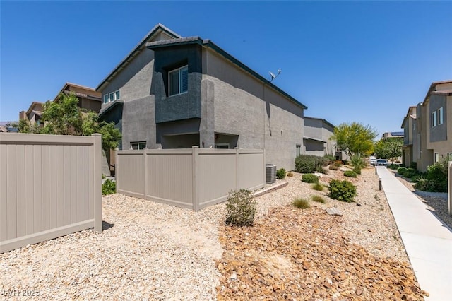 4519 Sapphire Moon Ave, North Las Vegas, NV 89084 - view of side of home featuring central AC, a residential view, and stucco siding