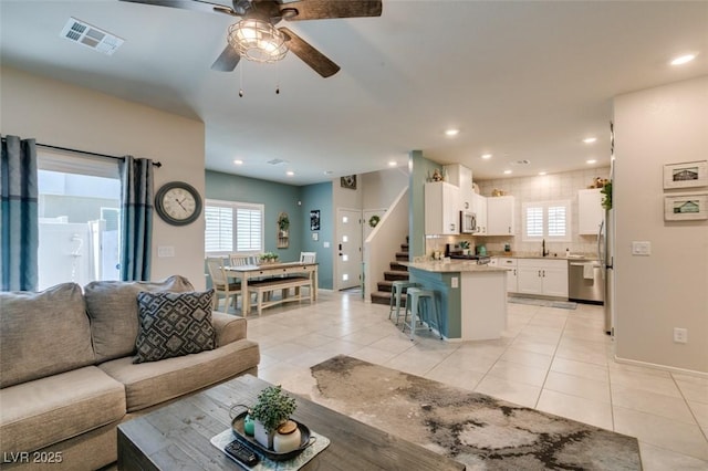 4519 Sapphire Moon Ave, North Las Vegas, NV 89084 - living room featuring ceiling fan, stairs, light tile patterned floors, healthy amount of natural light, and recessed lighting