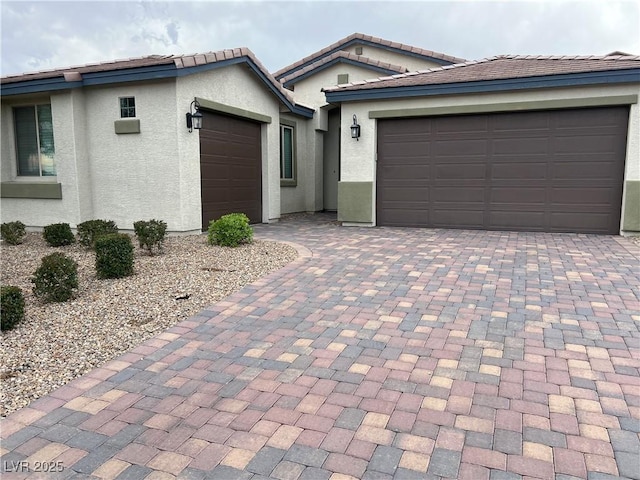7265 Southern Magnolia St, Las Vegas, NV 89149 - ranch-style home featuring a garage, decorative driveway, stucco siding, and a tiled roof