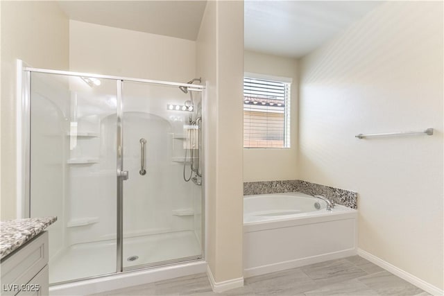 7265 Southern Magnolia St, Las Vegas, NV 89149 - bathroom featuring a stall shower, a garden tub, baseboards, and vanity