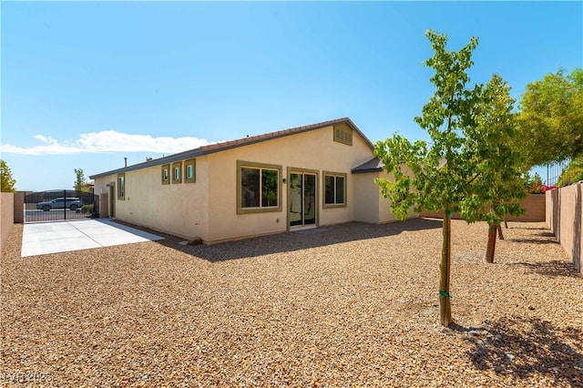 7265 Southern Magnolia St, Las Vegas, NV 89149 - rear view of property featuring stucco siding, a fenced backyard, and a patio