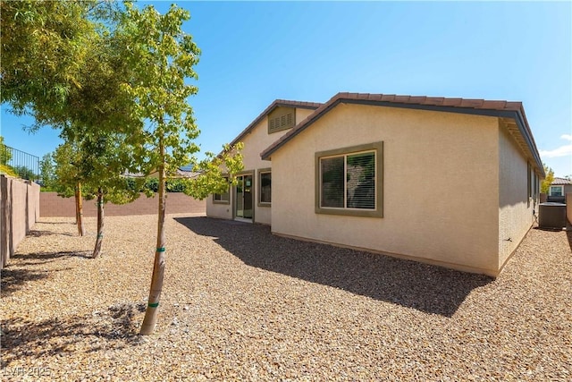 7265 Southern Magnolia St, Las Vegas, NV 89149 - back of property with a fenced backyard, central air condition unit, and stucco siding