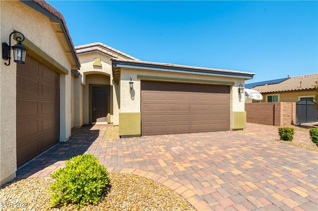 7265 Southern Magnolia St, Las Vegas, NV 89149 - view of front of house featuring stucco siding, a garage, decorative driveway, and a tiled roof