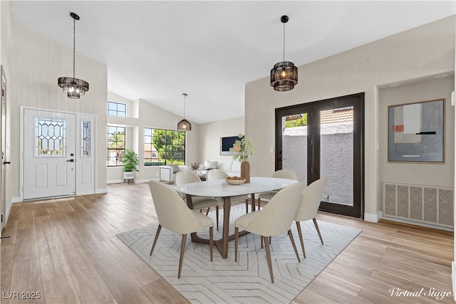 7221 W Washington Ave, Las Vegas, NV 89128 - dining space with baseboards, light wood-type flooring, a chandelier, and high vaulted ceiling
