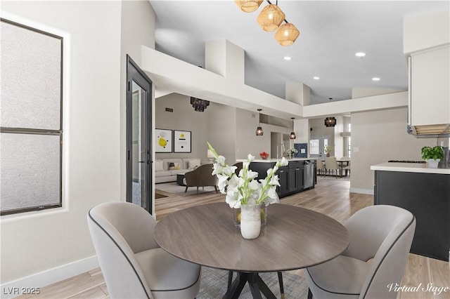 7221 W Washington Ave, Las Vegas, NV 89128 - dining space with vaulted ceiling, baseboards, light wood-style floors, and recessed lighting