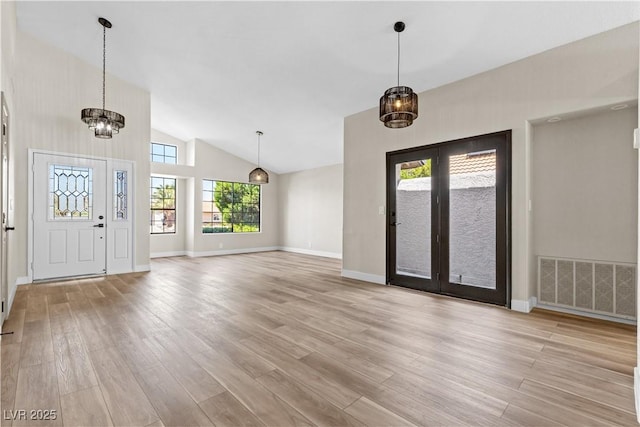 7221 W Washington Ave, Las Vegas, NV 89128 - entryway featuring light wood-style floors, a chandelier, baseboards, high vaulted ceiling, and french doors