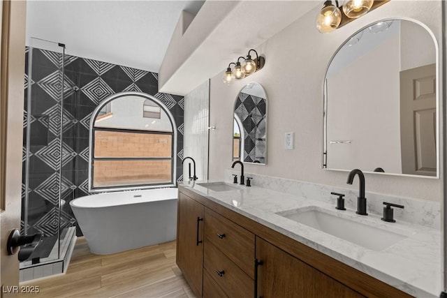 7221 W Washington Ave, Las Vegas, NV 89128 - full bath with double vanity, a soaking tub, and wood finished floors