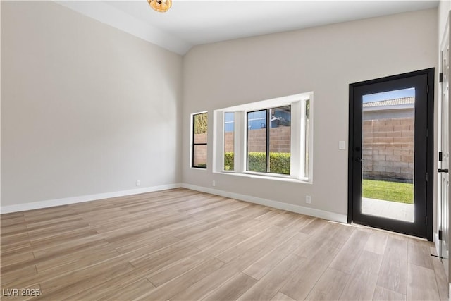 7221 W Washington Ave, Las Vegas, NV 89128 - spare room with light wood-style flooring, vaulted ceiling, and baseboards