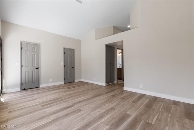7221 W Washington Ave, Las Vegas, NV 89128 - empty room with light wood-type flooring, baseboards, and high vaulted ceiling