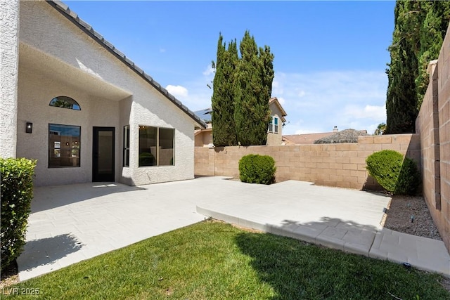 7221 W Washington Ave, Las Vegas, NV 89128 - fenced backyard with a patio