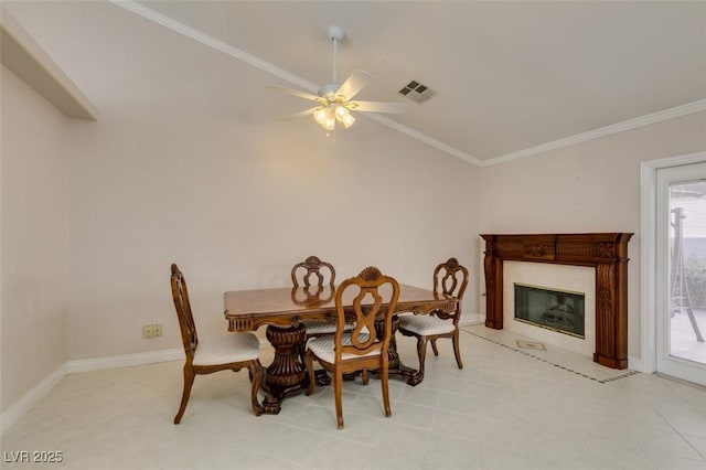 259 Baring Cross St, Henderson, NV 89074 - dining space with a ceiling fan, crown molding, a high end fireplace, vaulted ceiling, and baseboards
