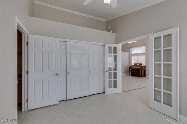 259 Baring Cross St, Henderson, NV 89074 - unfurnished bedroom with french doors, crown molding, a closet, light tile patterned flooring, and a ceiling fan