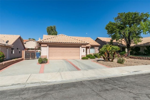 259 Baring Cross St, Henderson, NV 89074 - view of front of house featuring an attached garage, stucco siding, a tiled roof, and concrete driveway