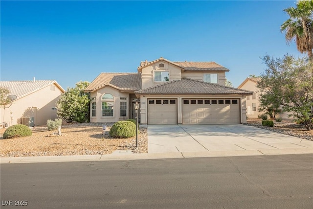 5133 Burr Oak Dr, Las Vegas, NV 89130 - mediterranean / spanish-style home featuring a tile roof, a garage, stucco siding, driveway, and central air condition unit