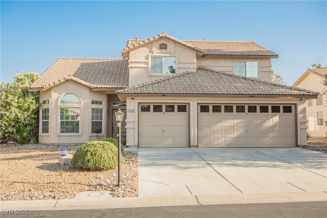 5133 Burr Oak Dr, Las Vegas, NV 89130 - view of front of home featuring a garage, concrete driveway, a tiled roof, and stucco siding