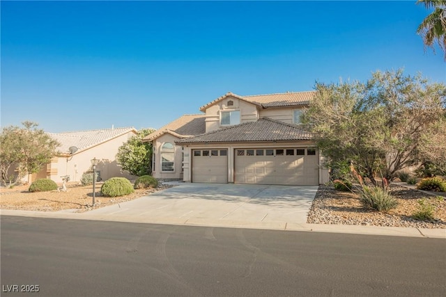 5133 Burr Oak Dr, Las Vegas, NV 89130 - view of front of house featuring a tile roof, an attached garage, driveway, and stucco siding