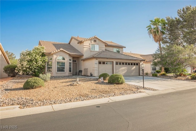 5133 Burr Oak Dr, Las Vegas, NV 89130 - mediterranean / spanish-style home with an attached garage, a tiled roof, driveway, and stucco siding