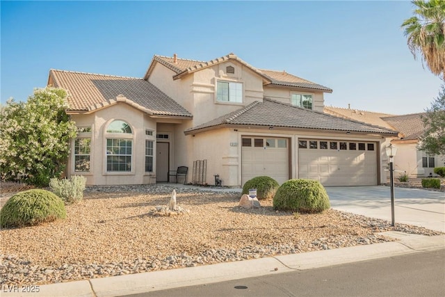 5133 Burr Oak Dr, Las Vegas, NV 89130 - mediterranean / spanish house with an attached garage, driveway, a tiled roof, and stucco siding