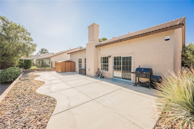 5133 Burr Oak Dr, Las Vegas, NV 89130 - rear view of house with a patio, stucco siding, a tile roof, and a chimney