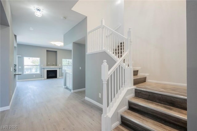5133 Burr Oak Dr, Las Vegas, NV 89130 - stairway with wood finished floors, baseboards, and a fireplace