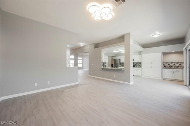5133 Burr Oak Dr, Las Vegas, NV 89130 - unfurnished living room with light wood-style floors and baseboards