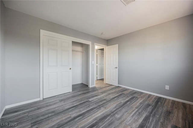5133 Burr Oak Dr, Las Vegas, NV 89130 - unfurnished bedroom with dark wood finished floors, baseboards, and a closet