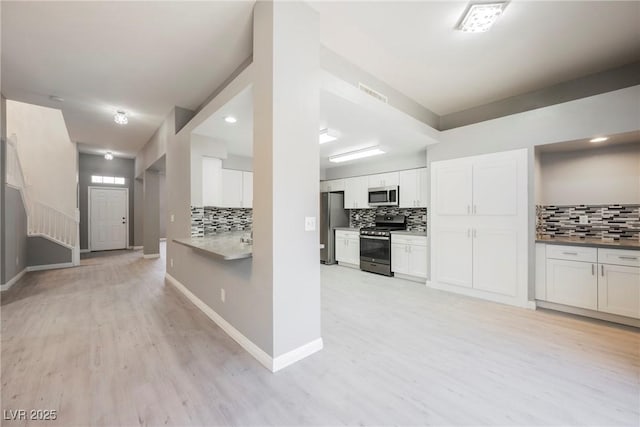 5133 Burr Oak Dr, Las Vegas, NV 89130 - kitchen with stainless steel appliances, decorative backsplash, and light wood finished floors