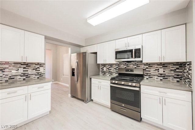 5133 Burr Oak Dr, Las Vegas, NV 89130 - kitchen with stainless steel appliances, decorative backsplash, and white cabinets