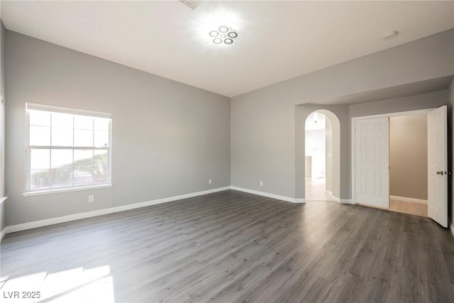 5133 Burr Oak Dr, Las Vegas, NV 89130 - spare room featuring dark wood-type flooring, arched walkways, baseboards, and a smoke detector