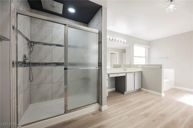 5133 Burr Oak Dr, Las Vegas, NV 89130 - bathroom with a shower stall, wood finished floors, vanity, and a bath