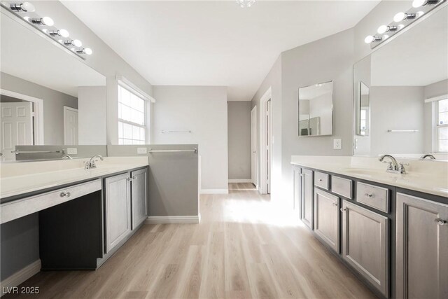 5133 Burr Oak Dr, Las Vegas, NV 89130 - full bathroom with wood finished floors, two vanities, and baseboards