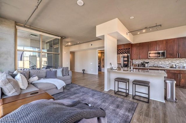 353 E Bonneville Ave Unit 379, Las Vegas, NV 89101 - living room featuring rail lighting and dark wood-type flooring