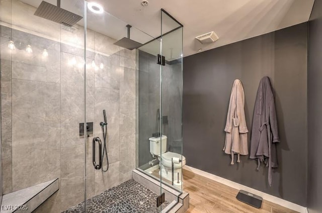 353 E Bonneville Ave Unit 379, Las Vegas, NV 89101 - full bathroom featuring a stall shower, wood finished floors, toilet, and baseboards