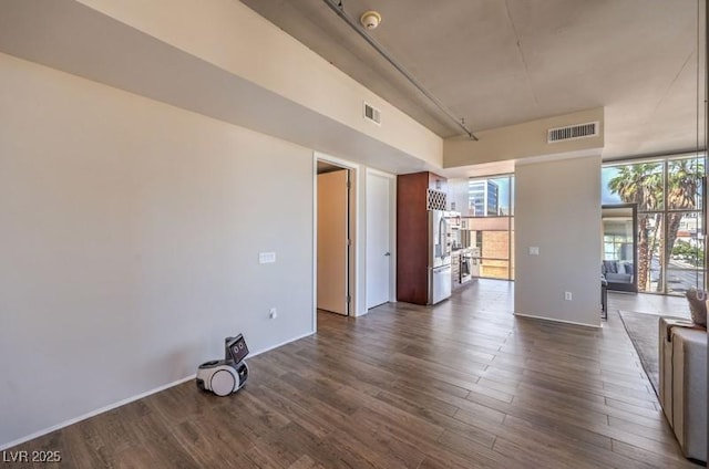 353 E Bonneville Ave Unit 379, Las Vegas, NV 89101 - empty room with dark wood finished floors and a smoke detector