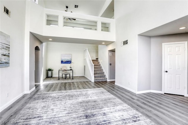 1833 Winners Cup Dr, Las Vegas, NV 89117 - foyer entrance with wood finished floors, baseboards, stairway, a high ceiling, and recessed lighting