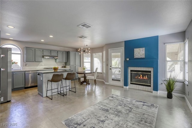 1833 Winners Cup Dr, Las Vegas, NV 89117 - kitchen featuring dishwasher, finished concrete flooring, a breakfast bar area, a chandelier, and recessed lighting