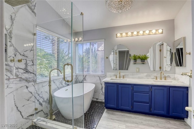 1833 Winners Cup Dr, Las Vegas, NV 89117 - bathroom with double vanity, a soaking tub, tile walls, wood finished floors, and a marble finish shower
