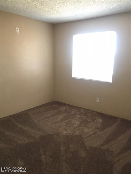5220 Mission Carmel Ln Unit 207, Las Vegas, NV 89107 - carpeted spare room featuring a textured ceiling
